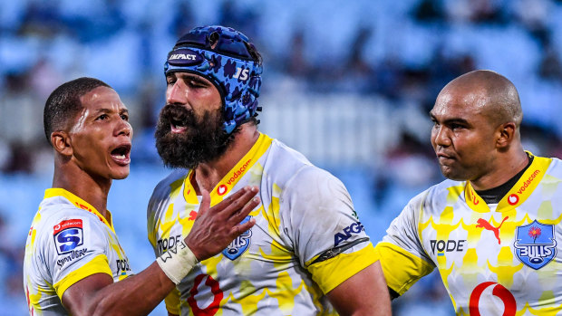 Josh Strauss of the Bulls celebrates with teammates after a try to Rosko Specman against the Highlanders.