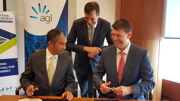 Vena Energy CEO Nitin Apte (left), Queensland Energy Minister Anthony Lynham (centre) and AGL CEO Brett Redman (right) sign the agreement for the new battery project.