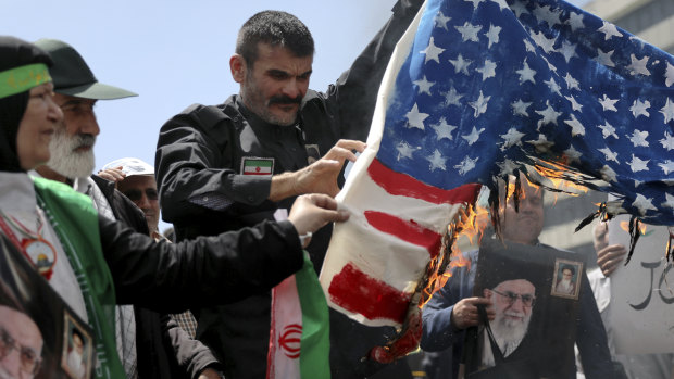 Iranian worshippers burn a US flag during a rally after Friday prayer in Tehran.