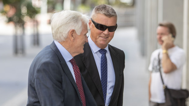 Ex-CFMEU boss Dave Hanna (right) arrives with his lawyers at the Supreme Court in Brisbane.