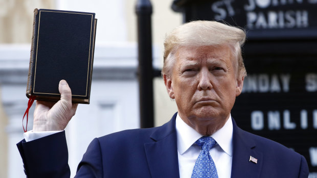 US President Donald Trump holds a Bible as he visits St John's Church, across Lafayette Park from the White House, on Monday.