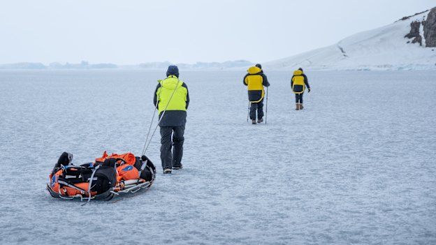 Hauling gear across a frozen epishelf lake back to camp.