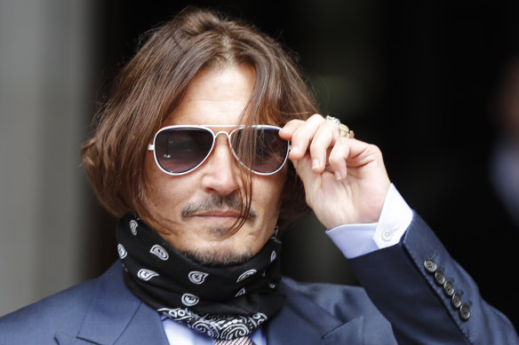 Johnny Depp arrives at the High Court in London on Friday. He is suing the publisher of The Sun newspaper for depicting him as a "wife beater".
