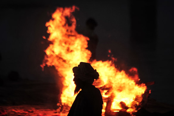 A funeral pyre for a person thought to have died from COVID-19 burns at a mass crematorium site on the banks of the Ganges river in May.