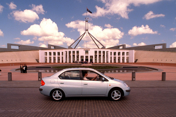 A little cluncky: A Prius is driven past Parliament House  at its Australian launch in 1998.