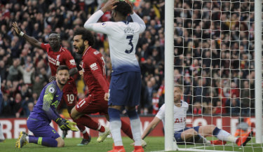 Liverpool celebrates after Tottenham's Toby Alderweireld scores an own goal late in the game.