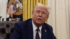 President Donald Trump answers questions from reporters after signing executive orders in the Oval Office.