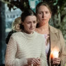 Sophie Roome is comforted by family, friends and the community of Lismore at a silent vigil for Rowan, 2, who was murdered by his father last Sunday.