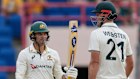 Alex Carey celebrates with partner Beau Webster after scoring a half-century against the West Indies during day one of the second Test.
