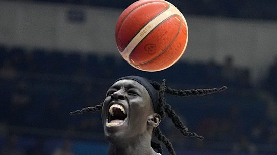 South Sudan centre Deng Acuoth scores against Angola at the FIBA World Cup and celebrates his country’s progression to the Olympics.