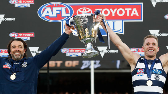 Chris Scott and Joel Selwood hold up the 2022 AFL premiership cup.