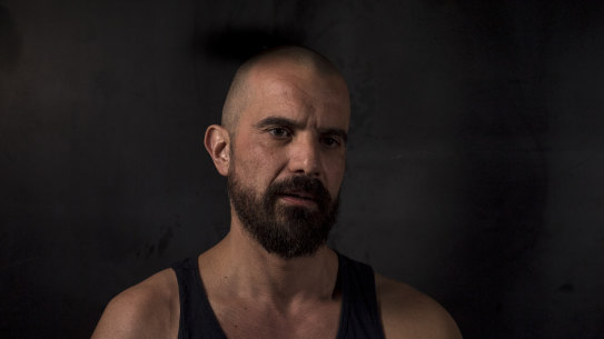 Nik Dimopolous' arm was shattered when he was mistakenly arrested during a brutal police raid in May