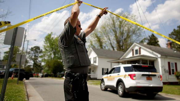 Law enforcement investigate the scene of a shooting in Elizabeth City, North Carolina, on Wednesday. An officer shot and killed a resident while serving a warrant.