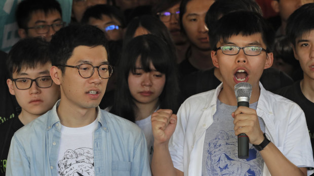Hong Kong activists Joshua Wong, right, and Nathan Law, left, speak outside court in 2017.