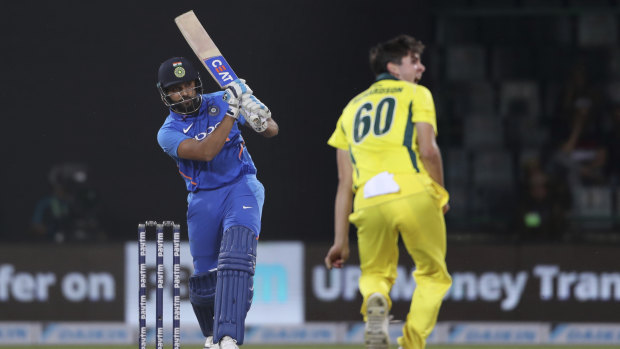 India's Rohit Sharma plays a shot as Australia's Jhye Richardson looks on.
