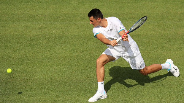 Bernard Tomic's Wimbledon campaign took less than an hour to fizzle out in a straight-sets loss to Jo-Wilfried Tsonga.