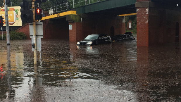 Cars trapped under the York Street Bridge on Albert Road in South Melbourne. 