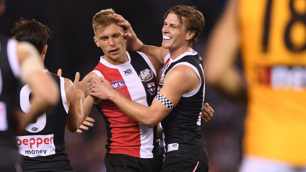 St Kilda's Seb Ross (second from left), who picked up 39 touches against Hawthorn on Sunday, celebrates a goal.