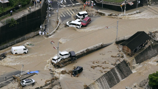 Roads are covered in mud waters after a landslide caused by heavy rains in Aki, Hiroshima prefecture, south-western Japan, on Saturday.