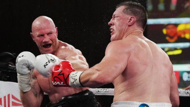 Barry Hall lands a blow on Paul Gallen in Melbourne on Friday night.