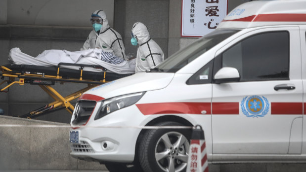 Medical staff transfer patients to hospital in Wuhan.