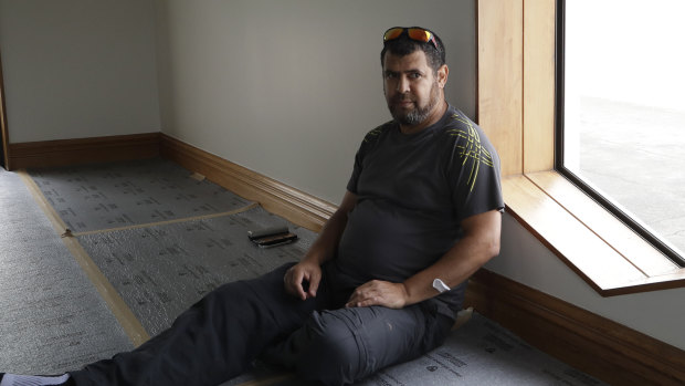 Survivor Tariq Chenafa sits by the the window he smashed to escape the gunman at the mosque in Christchurch, New Zealand. 