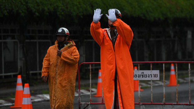 Thai police block the road in front of Chiang Rai Prachanukroh Hospital, where the first four boys were taken.