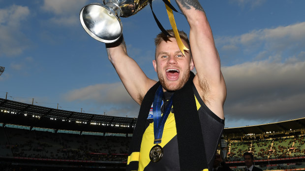 Brandon Ellis of the Tigers celebrates with the 2019 Premiership Cup.