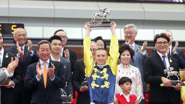 Bet with confidence: Zac Purton is presented with a trophy for the Hong Kong jockey championship.