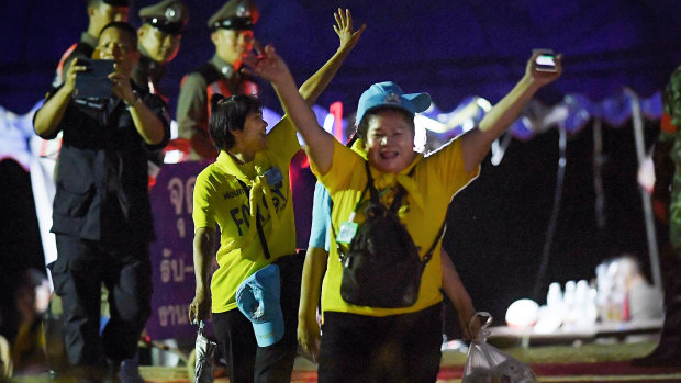 Thai volunteers cheer and yell ‘hooray’ as they return from Tham Luang cave after all 13 have been rescued. 