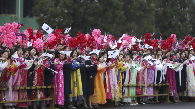 North Koreans greet the convoy transporting South Korean President Moon Jae-in.