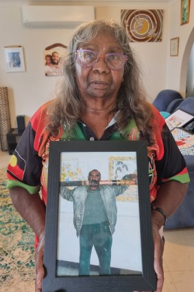 Doreen Webster holds a photo of her brother, Barkindji man Kevin Bugmy, who died in custody in 2019.