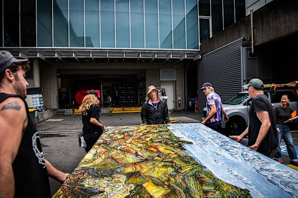 Matthew Cook (centre) unloads his painting at the Art Gallery of NSW, just in time to enter it for the Wynne Prize.
