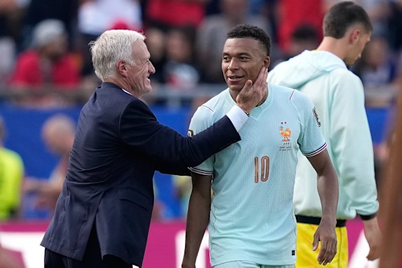 France head coach Didier Deschamps celebrates with Kylian Mbappe at the end of the match.