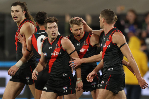 Dyson Heppell and the Bombers celebrate a goal.