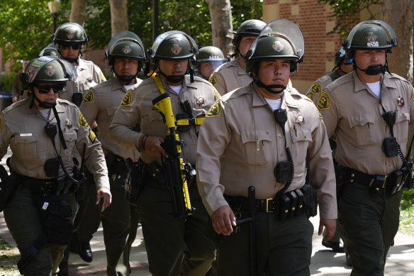 Police walk on the UCLA campus, after nighttime clashes between pro-Israel and pro-Palestinian groups.