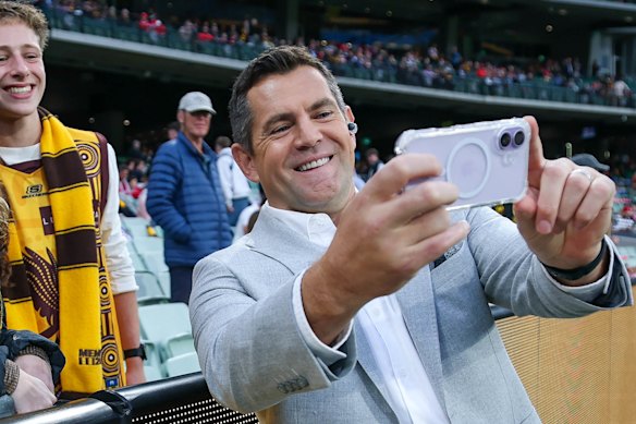 Luke Hodge poses for a selfie with footy fans while on the boundary for Channel Seven.