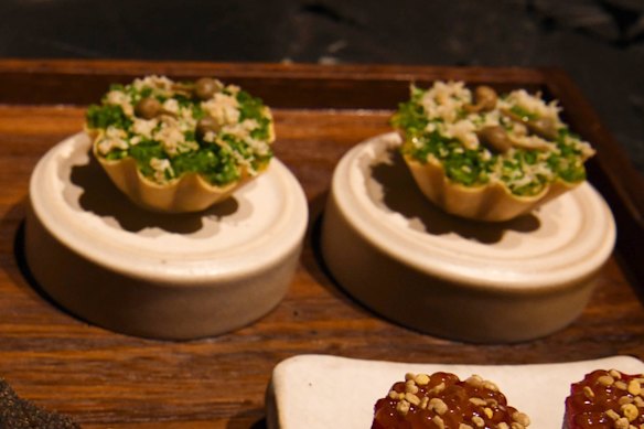 Wagyu tartare tarts with cured egg yolk, horseradish and chives.