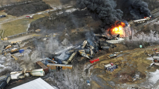 taken with a drone shows portions of a Norfolk Southern freight train that derailed Friday night in East Palestine, Ohio are still on fire the day after the derailment.