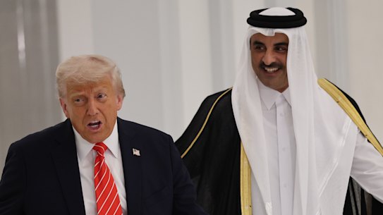 US President Donald Trump and Emir of Qatar Tamim bin Hamad Al Thani arrive for a state dinner at the Lusail Palace on in Doha, Qatar.