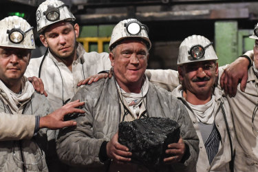 Miners hold the last lump of coal during a closing ceremony of the last German coal mine Prosper-Haniel in Bottrop, Germany on December 21, 2018.