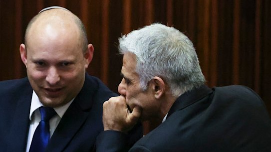 The new PMs: Yamina party leader Naftali Bennett, left, smiles as he speaks to Yesh Atid party leader Yair Lapid.