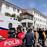 Turkish security forces and emergency workers in the school courtyard.