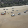 Emergency services at the site of a fatal rollover on Teewah Beach, Cooloola.