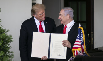 US President Donald Trump and Israeli Prime Minister Benjamin Netanyahu hold a signed proclamation that recognises Israeli sovereignty over the Golan Heights.