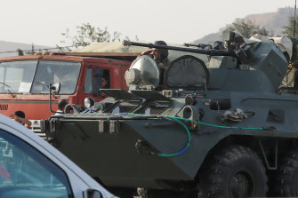 Azerbaijani military personnel drive through Baku, Azerbaijan, on Sunday.
