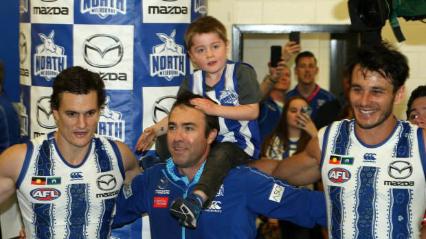 Once more with feeling: Brad Scott joins the Kangaroos to sing the team song for the last time.