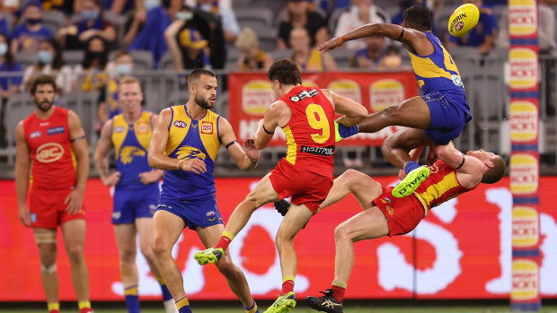 West Coast’s Willie Rioli collides with Gold Coast young gun Matt Rowell.