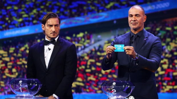 Ruud Gullit, former Netherlands player, draws France from the pot during the UEFA Euro 2020 draw in Bucharest.
