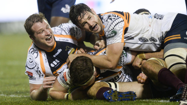 Pathway: The Brumbies celebrate a try in their big win over the Reds.